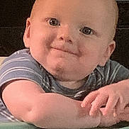 James joined the competition — help win amazing prizes! baby, child, infant, smile, face, eyes, hands, striped_shirt, plastic_surface, curious, indoor, portrait, cute, young, person, skin, head, expression, sitting, background