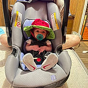 Emberlynn joined the competition — help win amazing prizes! baby, car_seat, pacifier, hat, infant, child, adult, smiling, indoor, wood_paneling, person, footwear, sneakers, fabric, seat, handle, floor, mattress, home, cute