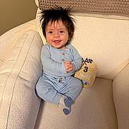 Bennett joined the competition — help win amazing prizes! baby, infant, smiling, spiky_hair, blue_onesie, socks, armchair, cushion, milestone_card, three_months, milestone, cozy, textured_fabric, portrait, happy, sitting, hands_clasped, indoor, nursery, soft_lighting
