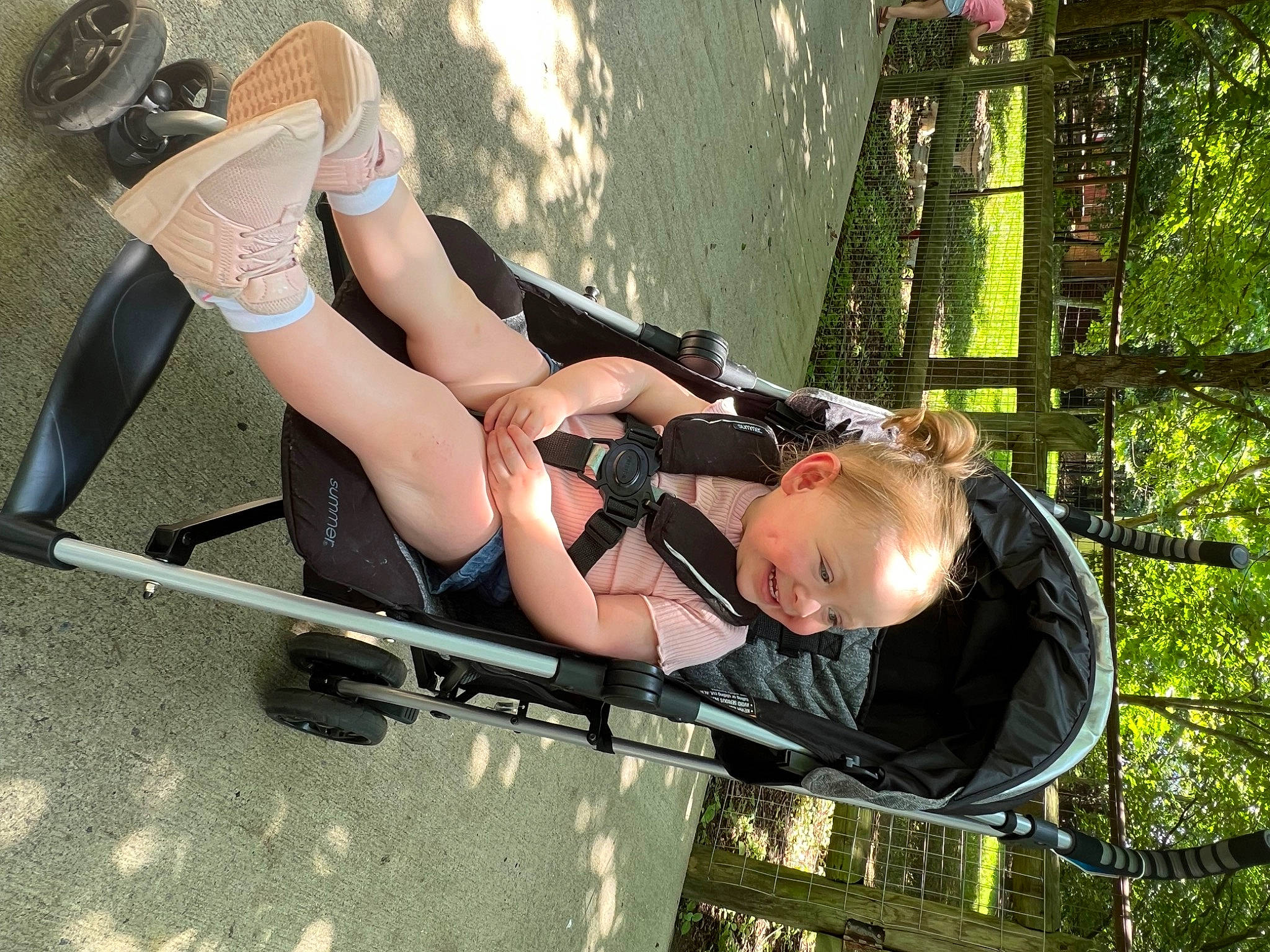 Kinslee is registered to the contest to win money with this photo: automotive_design, automotive_tire, automotive_wheel_system, calf, eyewear, foot, fun, grass, human_leg, knee, leisure, people_in_nature, person, personal_protective_equipment, recreation, sandal, shorts, sitting, thigh, tire