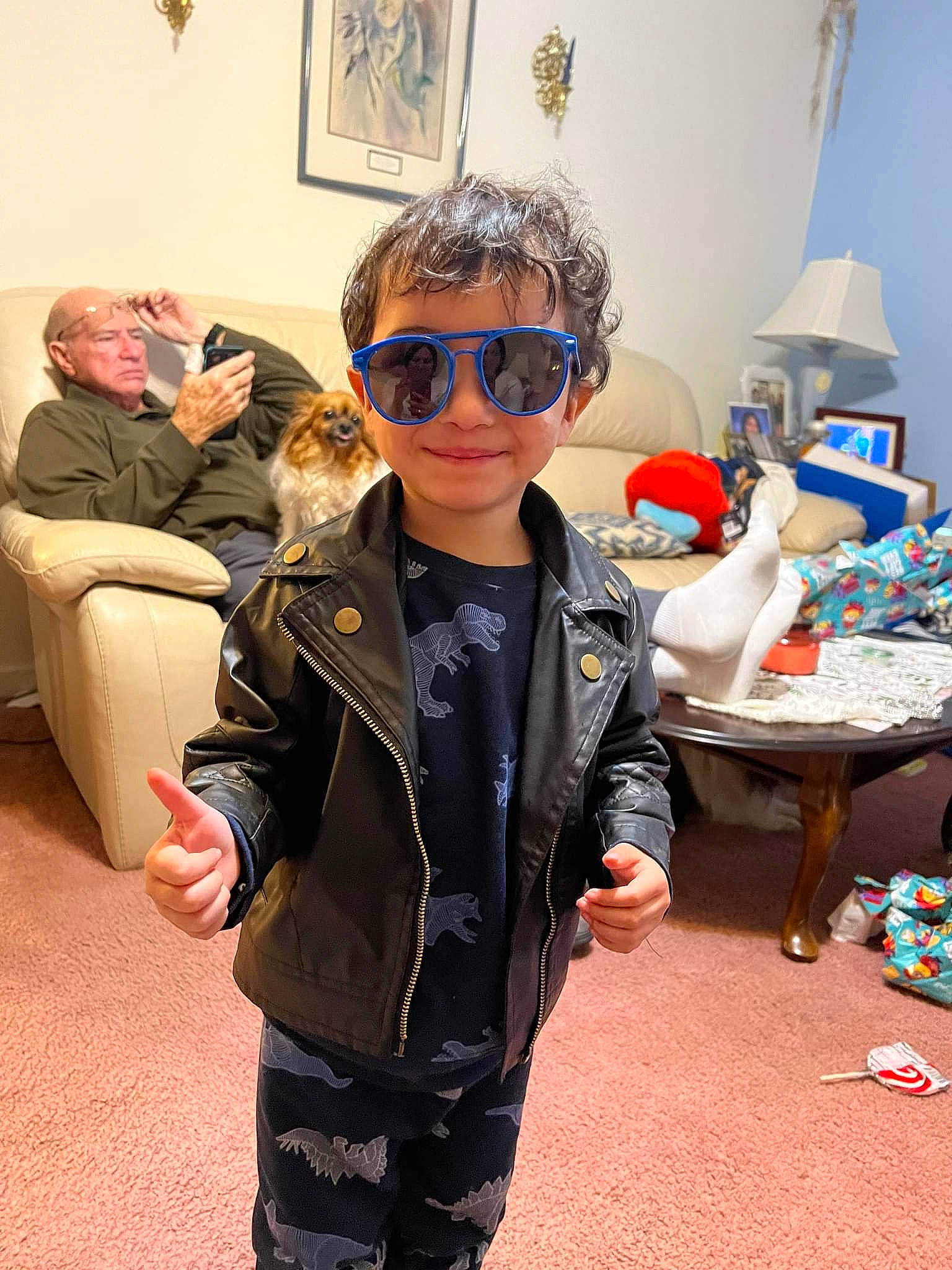 Lance is registered to the contest to win money with this photo: child, costume, event, eyewear, fashion_design, flooring, fun, goggles, jacket, joy, leisure, person, personal_protective_equipment, picture_frame, room, sleeve, sunglasses, table, toddler, vacation