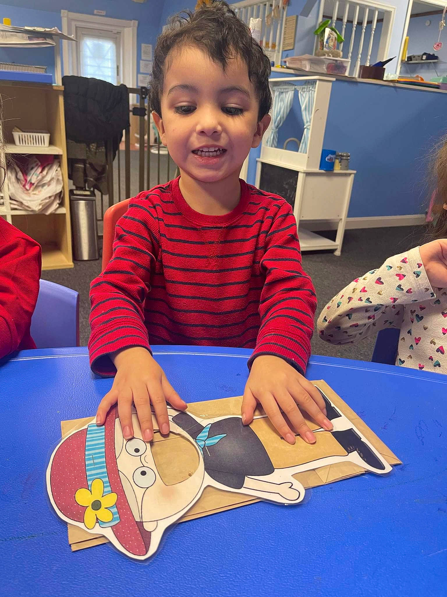 Lance joined the competition — help win amazing prizes! art, artist, carmine, chair, child, finger, flooring, fun, indoor_games_and_sports, leisure, person, play, recreation, room, sharing, shelf, sitting, smile, t_shirt, table