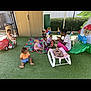 Aurorah is registered to the contest to win money with this photo: baby, blanket, caregiver, child, colorful, daycare, engagement, fence, grass, group, happy, interaction, outdoor, play_structure, playground, sitting, sunlight, toddler, toy, young_children