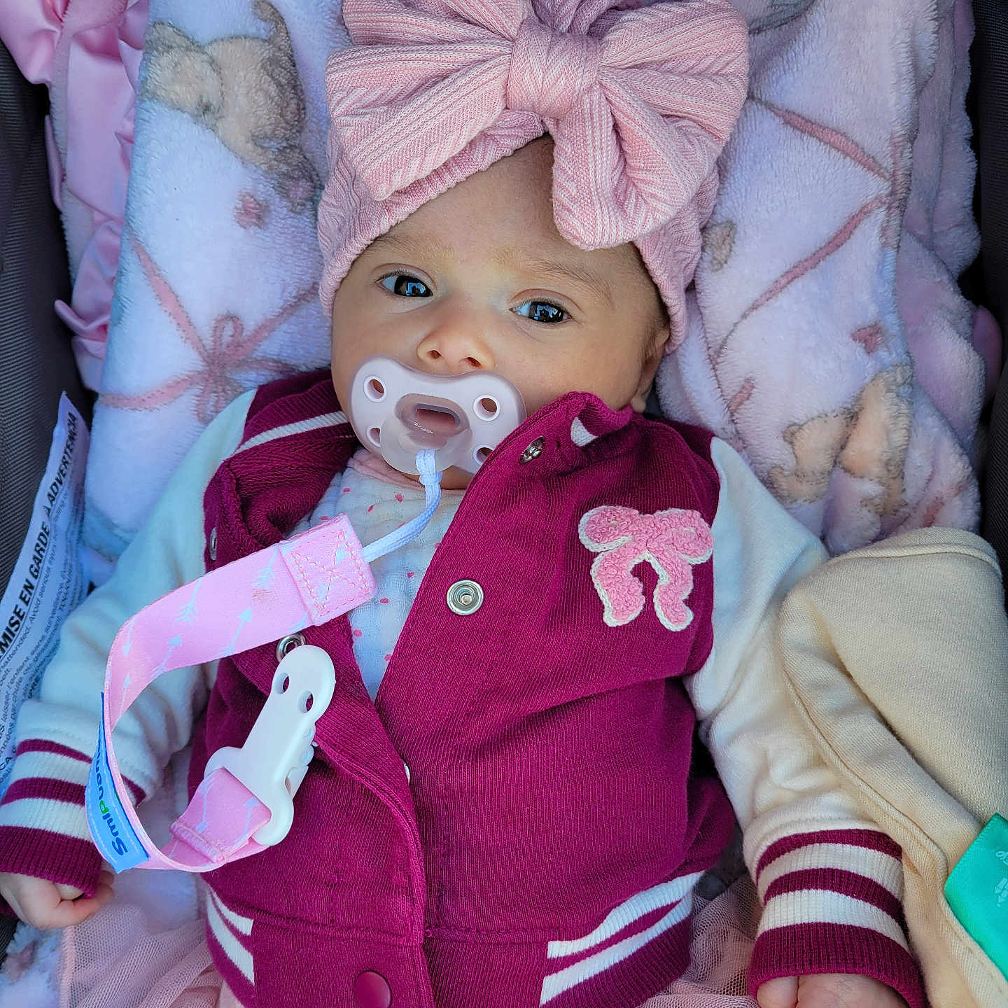 Selene joined the competition — help win amazing prizes! baby, infant, child, portrait, lying_down, pacifier, bow, headband, jacket, pink, burgundy, blanket, clothing, skirt, baby_carrier, smiling, face, eyes, indoor, cozy