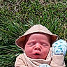 newborn, baby, infant, sleeping, outdoors, grass, plants, nature, sun_hat, pink_clothing, blanket, cuddly, portrait, close_up, face, peaceful, daylight, garden, floral, resting