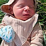 Atlas is registered to the contest to win money with this photo: newborn, baby, sleeping, infant, portrait, outdoor, grass, sun_hat, mittens, dinosaur_print, clothing, cozy, peaceful, face, closed_eyes, natural_light, greenery, closeup, lying_down, family_photo