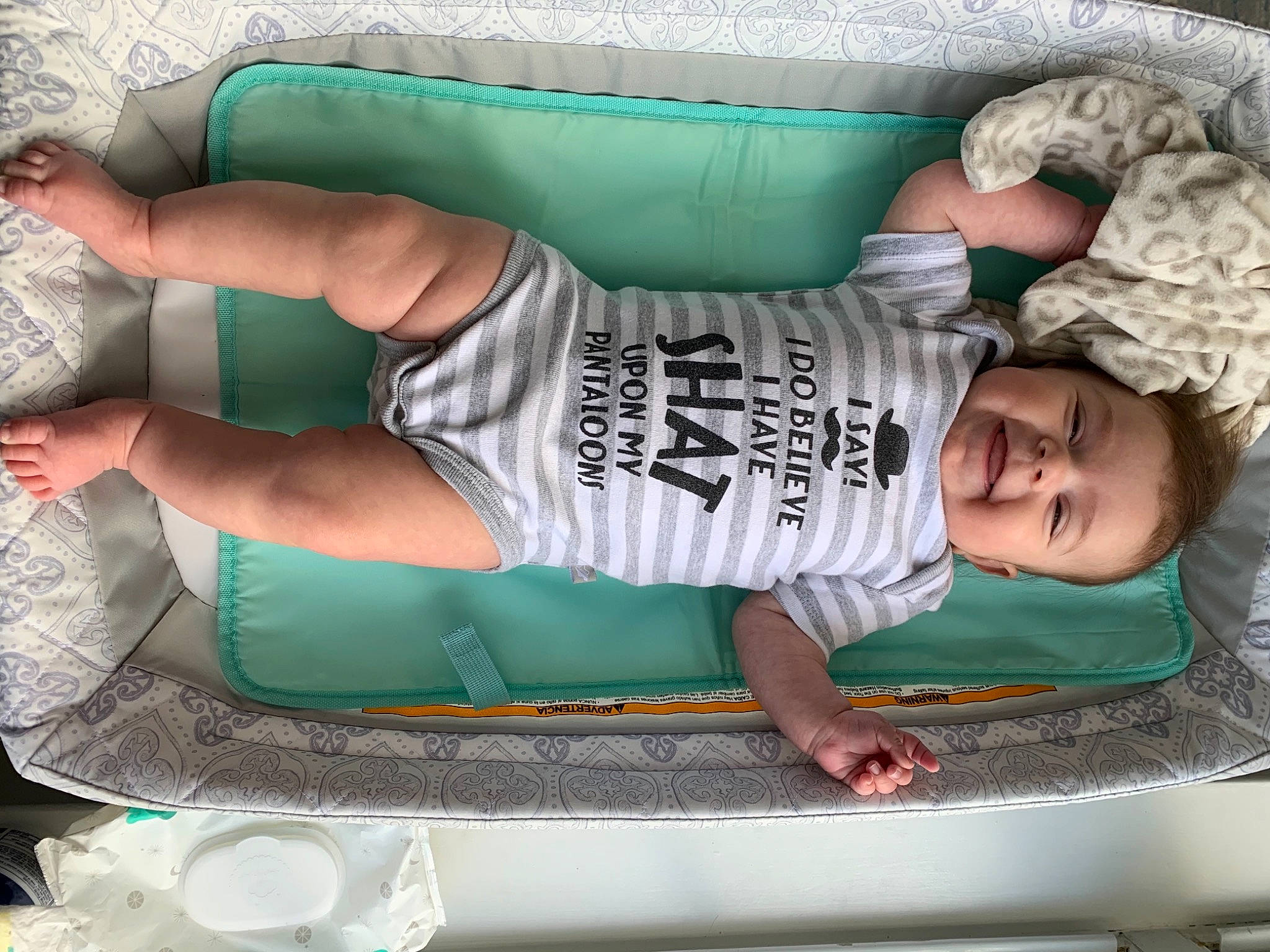 Gabrielle is registered to the contest to win money with this photo: arm, child, comfort, elbow, fun, green, human_leg, knee, leisure, muscle, pattern, person, recreation, shorts, smile, t_shirt, textile, thigh, toddler, trunk