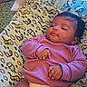 baby, infant, diaper, blanket, pink_sweater, honest_diapers, box, patterned_blanket, indoor, child, cute, relaxed, baby_clothing, floor, carpet, smiling_baby_image, baby_hands, baby_legs, soft_texture, home