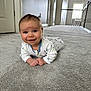 baby, infant, carpet, smiling, indoor, hallway, floor, clothing, person, cute, child, home, natural_light, window, door, white_wall, happy, lying_down, portrait, young_child