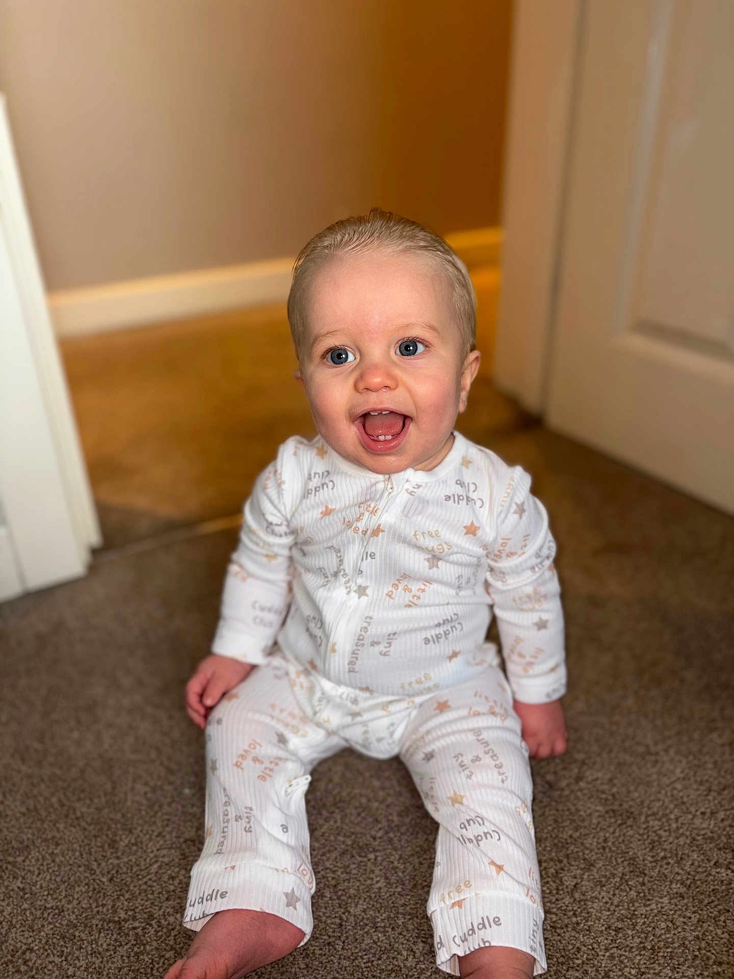 Kaven joined the competition — help win amazing prizes! baby, child, smiling, happy, pajamas, indoor, carpet, blue_eyes, sitting, cute, infant, home_interior, door, floor, clothing, person, portrait, young_child, baby_girl_or_boy, expression