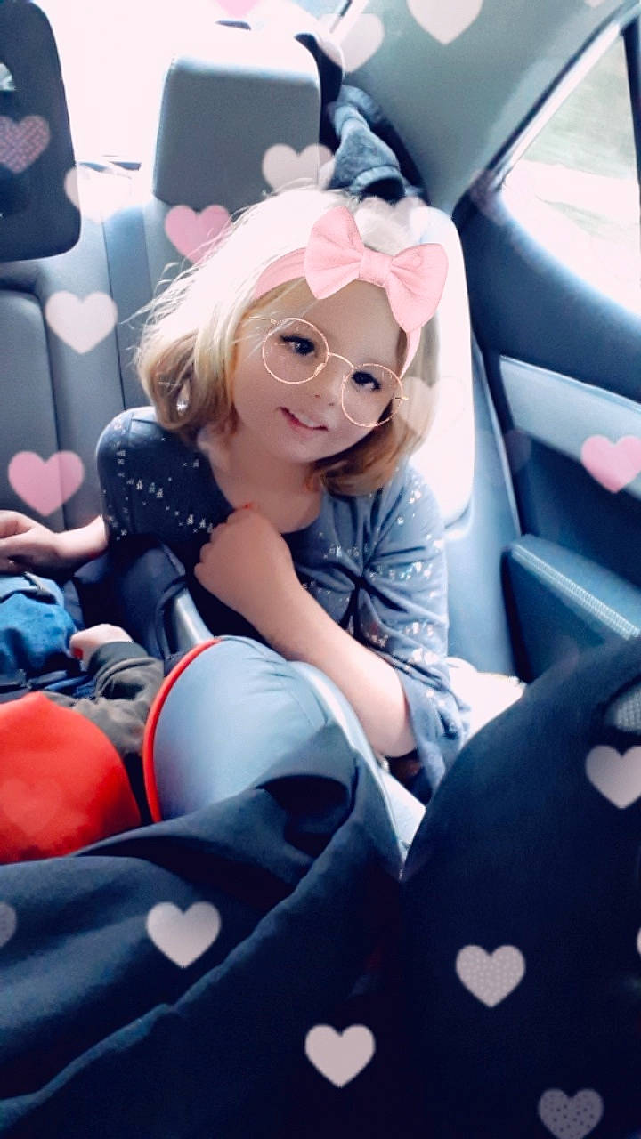 Ashlynn is registered to the contest to win money with this photo: auto_part, blond, car, car_seat, city_car, costume, driving, family_car, long_hair, person, plant, seat_belt, sitting, steering_wheel, vehicle, vehicle_door