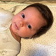 Roxanne participe au concours pour gagner de l'argent avec cette photo : baby, blanket, child, cozy, crib, cute, eyes, face, hair, indoors, infant, lying_down, newborn, portrait, quilted, resting, sleepwear, smile, soft, young