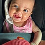 arm, baby, car_seat, cheeks, child, closeup, cute, eyes, face, hair, happy, indoor, infant, person, pink_clothing, plush_toy, seatbelt, skin, smile, toy