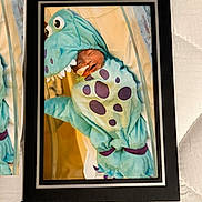 Riley is registered to the contest to win money with this photo: newborn, baby, costume, dinosaur, sleeping, wrapped, cute, hospital, nasal_tube, infant, soft, blue, purple_spots, plush, portrait, framed_photo, peaceful, child, cute_outfit, sleep