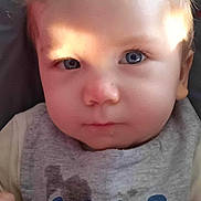Graham participe au concours pour gagner de l'argent avec cette photo : baby, child, face, blue_eyes, bib, clothing, closeup, expression, indoor, person, portrait, serious, young_child, sitting, light, natural_light, cute, infant, head, skin