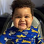 Harlem joined the competition — help win amazing prizes! child, baby, smile, high_chair, onesie, curly_hair, chubby_cheeks, portrait, indoor, cute, teeth, close_up, blue_clothing, animal_print, happy, face, infant, seat, background_blur, soft_lighting