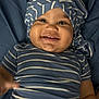 baby, infant, smile, smiling, striped_hat, striped_shirt, blue_clothing, hat, onesie, chubby_cheeks, tooth, portrait, close_up, lying_down, bedding, blanket, cute, happy, eye_contact, skin