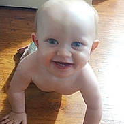 Alvin is registered to the contest to win money with this photo: baby, child, crawling, floor, wooden_floor, smiling, happy, indoor, skin, hands, face, eyes, mouth, infant, person, cute, young_child, home, natural_light, bare_chest