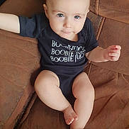 Orion is registered to the contest to win money with this photo: baby, barefoot, bodypart, chair, clothing, couch, cushion, face, finger, furniture, hand, head, pants, person, photography, portrait, shorts, sitting, t_shirt, toe
