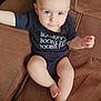 baby, barefoot, bodypart, chair, clothing, couch, cushion, face, finger, furniture, hand, head, pants, person, photography, portrait, shorts, sitting, t_shirt, toe