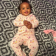 Malanyi is registered to the contest to win money with this photo: baby, infant, child, smiling, onesie, floral_pattern, blanket, cozy, lying_down, happy, cute, indoors, portrait, hands_clasped, footed_pajamas, patterned_blanket, soft_texture, baby_girl, relaxed, sleepwear