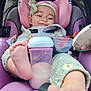 baby, infant, car_seat, bottle, milk, feet, headband, smile, toy, purple, clothing, seatbelt, child, cute, playful, comfort, closeup, indoor, person, portrait