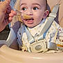 Luna'Rae joined the competition — help win amazing prizes! baby, high_chair, feeding, spoon, food, child, indoor, kitchen, person, seatbelt, curious, cute, eating, infant, face, hand, clothing, table, appliance, home