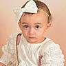 Luna'Rae joined the competition — help win amazing prizes! baby, big_eyes, bow, child, close_up, fair_skin, headband, indoor, looking_at_camera, photography, pink_background, portrait, ruffled_sleeves, serious_expression, sitting, soft_lighting, studio, sweater, toddler, white_clothing