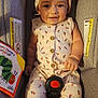 Luna'Rae joined the competition — help win amazing prizes! baby, infant, car_seat, romper, headband, bow, smiling, book, very_hungry_caterpillar, child, cute, patterned_clothing, seatbelt, indoors, portrait, happy, face, sitting, toy, child_reading