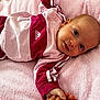 baby, infant, child, pink_blanket, adidas_clothing, sporty_outfit, lying_down, cute, portrait, face, hand, soft_texture, relaxed, indoor, closeup, smiling, young_child, casual_wear, comfortable, resting