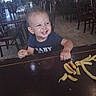 Micaiah is registered to the contest to win money with this photo: toddler, child, baby, smiling, laughing, portrait, restaurant, dining_room, table, chairs, food, french_fries, snack, eating, short_hair, blue_shirt, baby_clothing, indoor, happy, photograph
