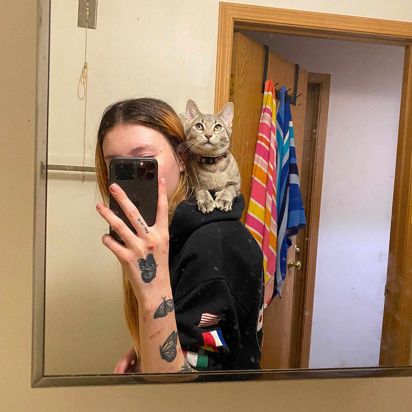 Edana joined the competition — help win amazing prizes! bathroom, butterfly_tattoo, casual, cat, door, gray_cat, hand, hoodie, indoor, mirror, person, phone, reflection, selfie, shoulder, smartphone, striped_towel, tattoo, towel, wooden_door