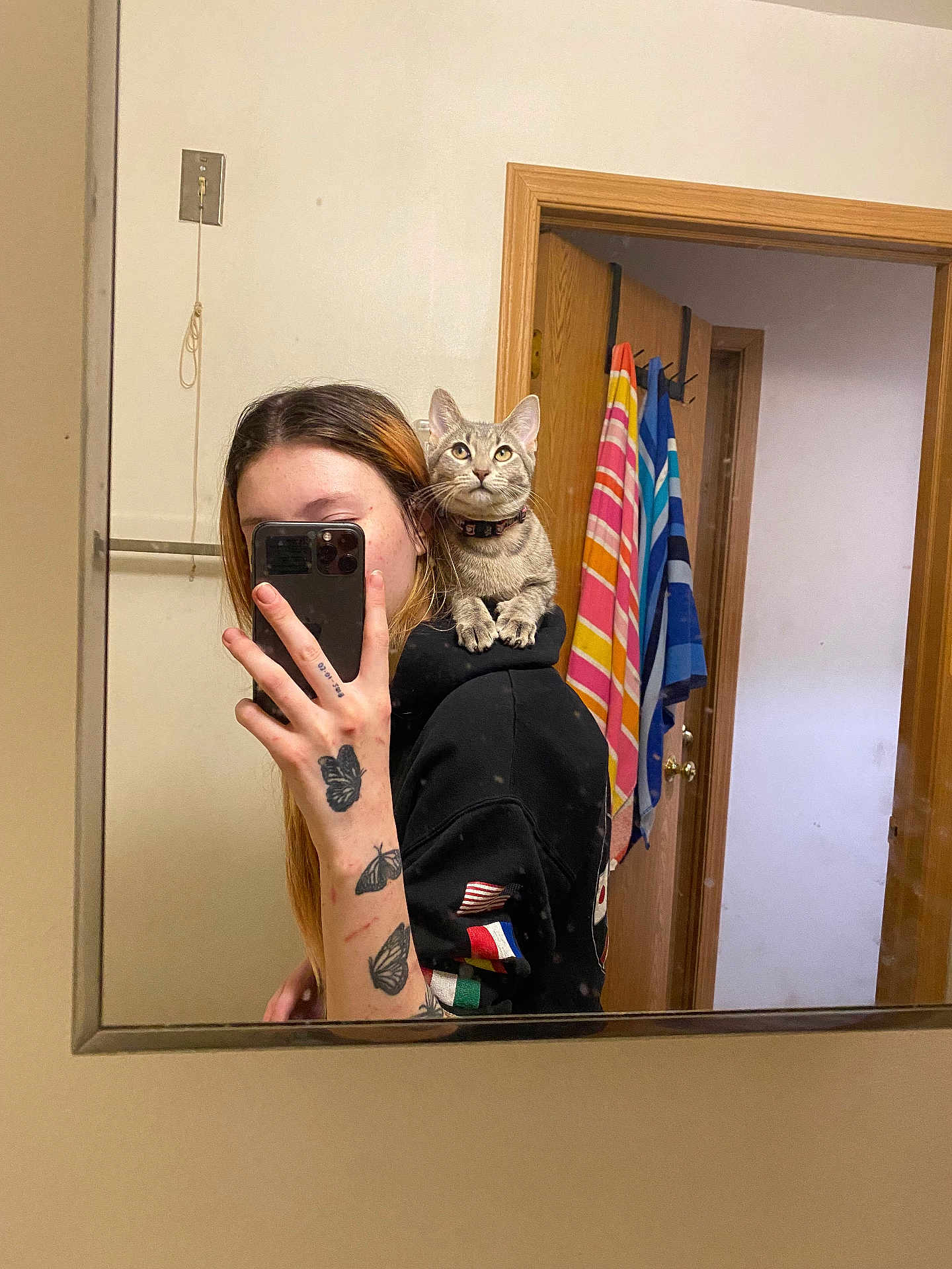 Edana joined the competition — help win amazing prizes! bathroom, butterfly_tattoo, casual, cat, door, gray_cat, hand, hoodie, indoor, mirror, person, phone, reflection, selfie, shoulder, smartphone, striped_towel, tattoo, towel, wooden_door