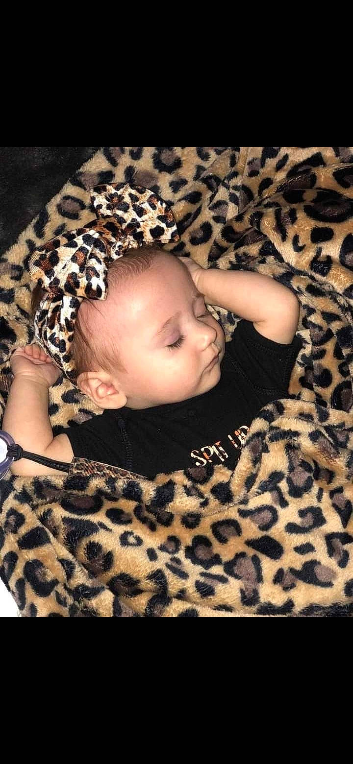 Kaylyn is registered to the contest to win money with this photo: baby, baby_toddler_clothing, brown, cheek, child, comfort, eye, face, fashion_accessory, flash_photography, flooring, grass, hairstyle, head, pattern, person, sitting, skin, sleeve, toddler