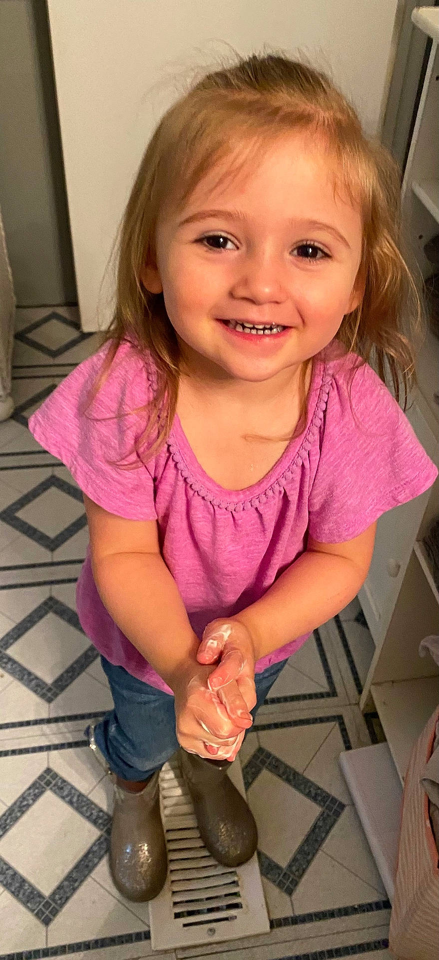 Kaylyn is registered to the contest to win money with this photo: bodypart, child, clothing, door, face, female, finger, footwear, girl, hand, happy, head, mouth, pants, person, photography, portrait, shoe, sleeve, smile