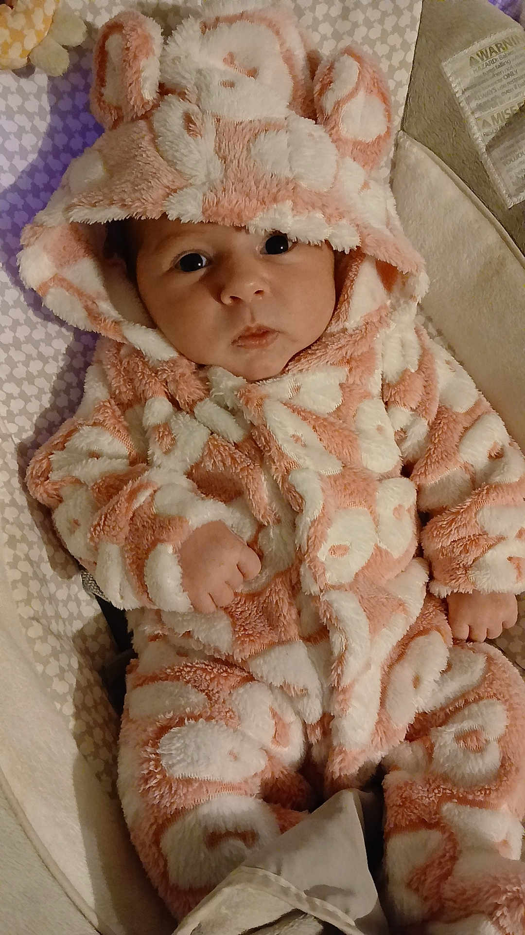 Cloëly participe au concours pour gagner de l'argent avec cette photo : baby, infant, onesie, hood, pink, white, fluffy, animal_ears, cute, face, eyes, hand, cushion, pattern, soft, child, portrait, indoor, warm, cozy