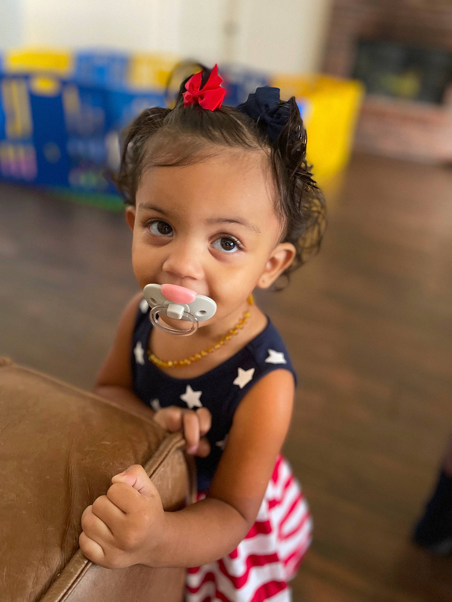 Avani is registered to the contest to win money with this photo: baby, baby_toddler_clothing, cheek, child, dress, ear, eyelash, fashion_accessory, fun, hair_accessory, hair_tie, happy, iris, jewellery, nail, necklace, person, room, sitting, skin