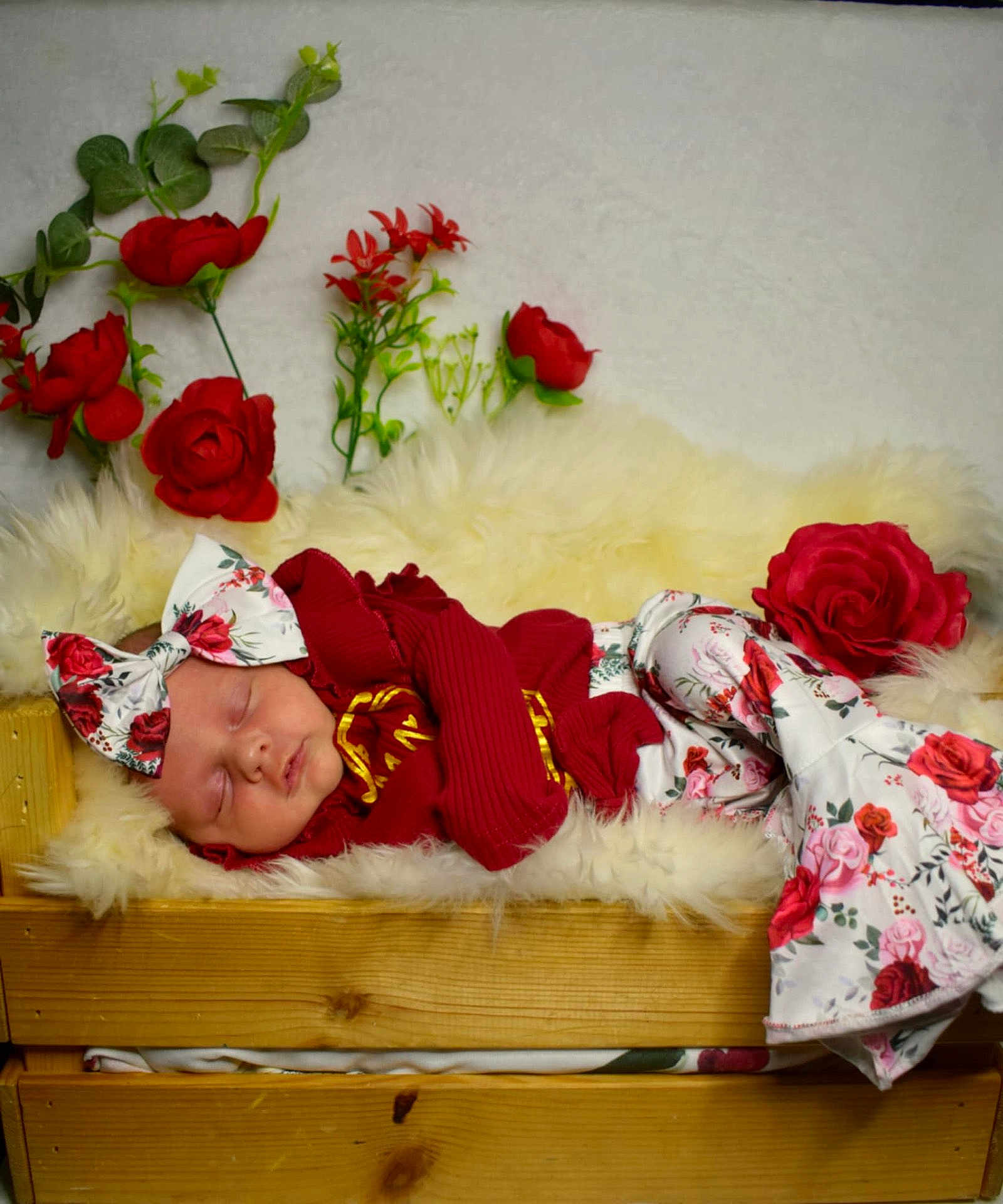 Aria joined the competition — help win amazing prizes! baby, sleeping, newborn, red_clothing, headband, floral_pattern, wooden_crate, fluffy_blanket, artificial_flowers, red_roses, green_leaves, cozy, portrait, indoor, soft_lighting, cute, infant, peaceful, decor, resting
