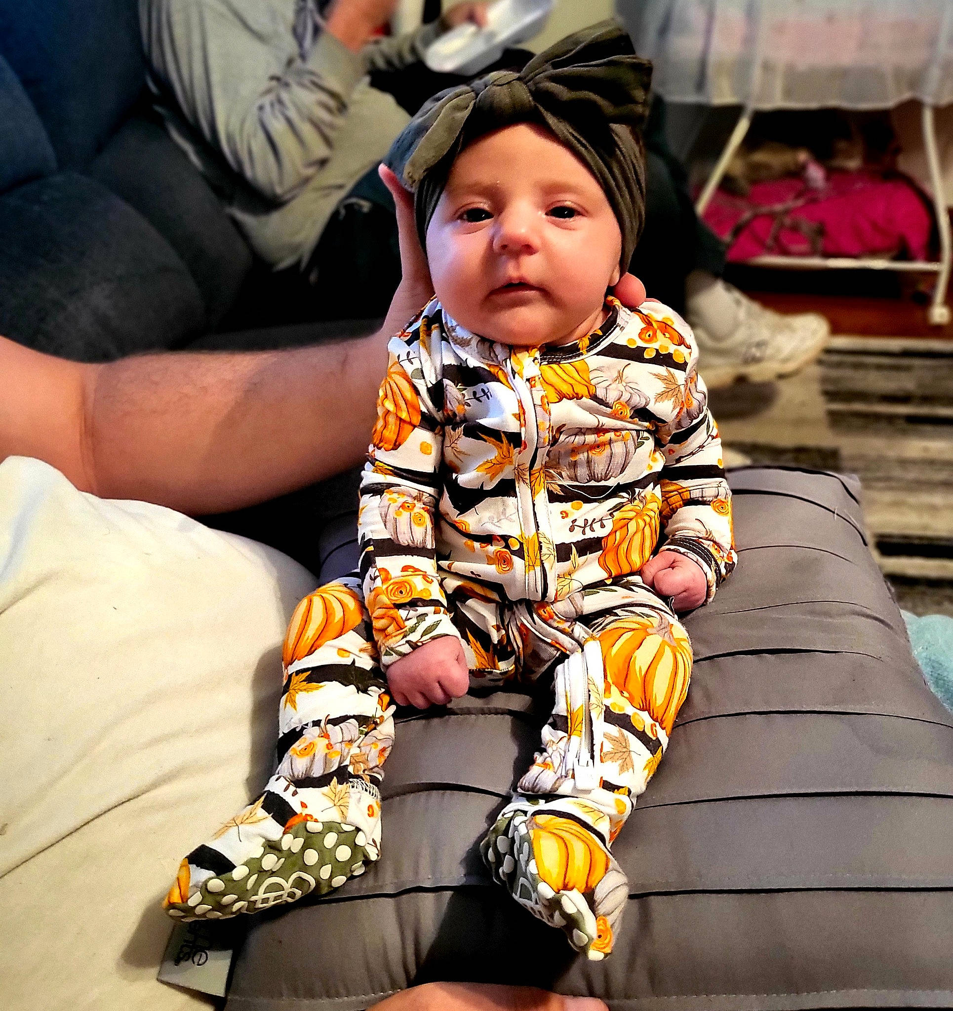 Addi is registered to the contest to win money with this photo: baby, baby_toddler_clothing, child, comfort, couch, eyewear, face, fun, happy, head, headwear, human_leg, knee, lap, leisure, pattern, person, sitting, sleeve, street_fashion