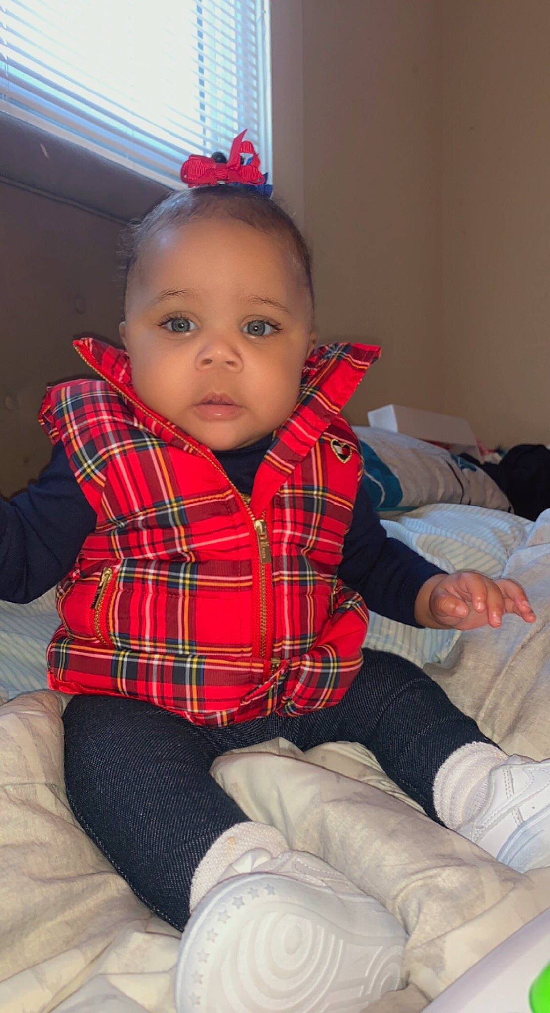 Aniyah Dior Marshall is registered to the contest to win money with this photo: baby_toddler_clothing, comfort, facial_expression, finger, fun, hairstyle, human_body, joint, knee, lap, leg, lip, person, plaid, skin, sleeve, sock, standing, tartan, textile