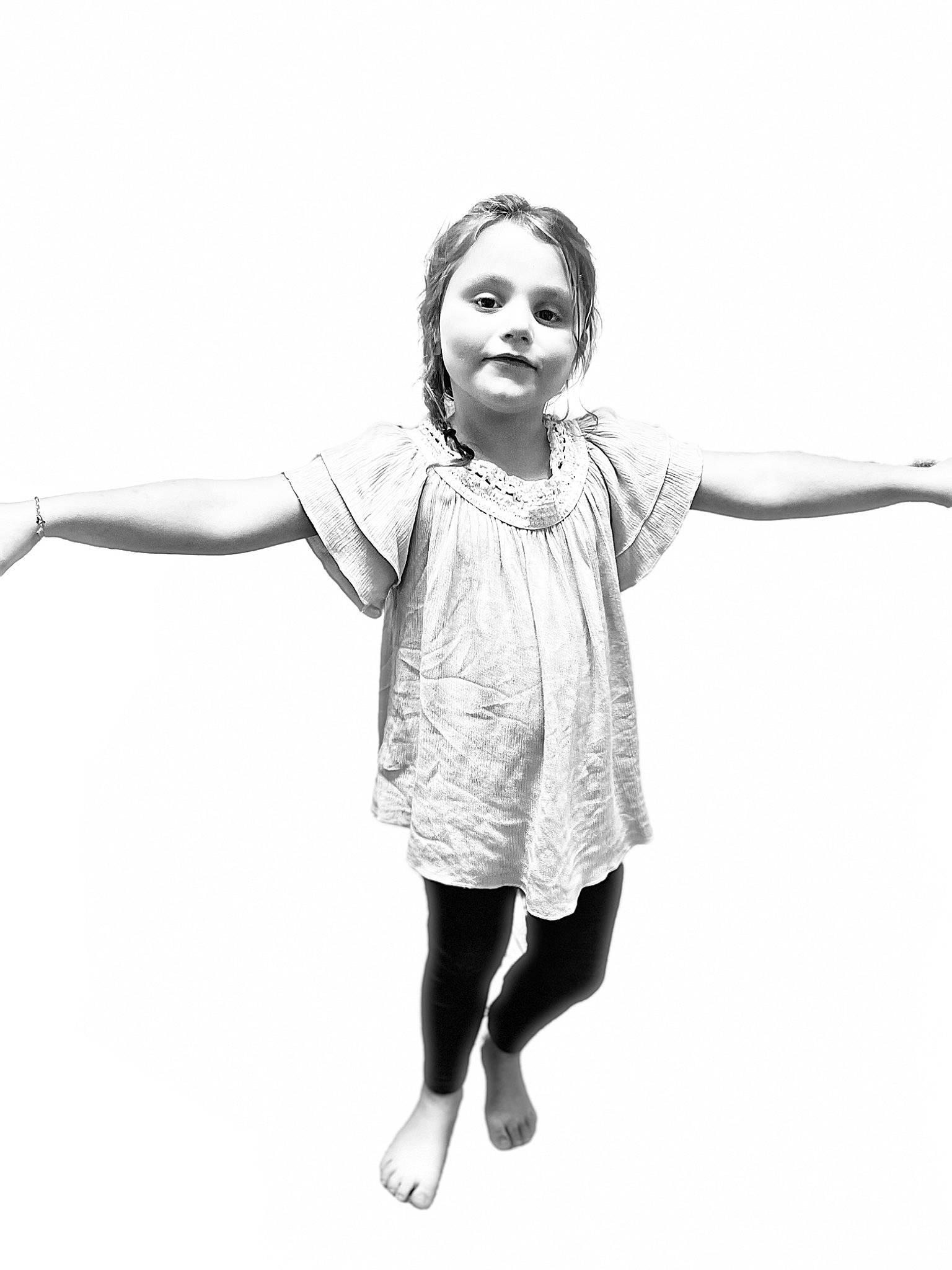 Kyla is registered to the contest to win money with this photo: arm, black_and_white, day_dress, elbow, fashion_design, finger, flash_photography, gesture, happy, human_leg, joint, knee, leg, one_piece_garment, person, shoulder, sleeve, style, thumb, waist