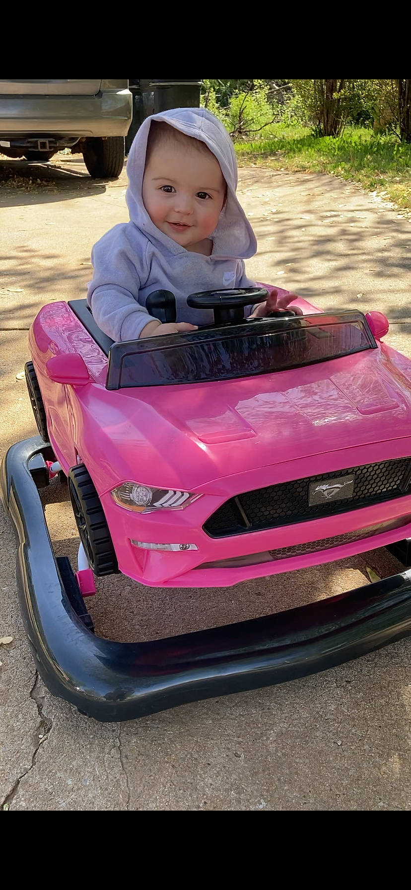 Lillianna is registered to the contest to win money with this photo: automotive_design, automotive_exterior, automotive_lighting, automotive_tire, bumper, car, eye, fender, grass, grille, hood, motor_vehicle, person, pink, plant, red, tire, toddler, vehicle, vehicle_registration_plate