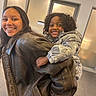 child, children, smiling, piggyback, leather_jacket, curly_hair, braces, indoor, happy, person, coats, jackets, frosted_glass, background, portrait, playful, sibling, young, casual, fun