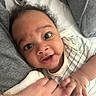 Carmello joined the competition — help win amazing prizes! baby, bed, blanket, child, close_up, comfort, curly_hair, cute, family, fingers, hand, indoors, infant, lying_down, pacifier, person, skin, smile, soft_toys, striped_clothing