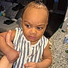 Carmello joined the competition — help win amazing prizes! toddler, child, striped_clothing, hair_buns, indoor, granite_countertop, hand_holding, curious_expression, person, home, kitchen, furniture, face, skin, young_child, standing, person_holding, casual, room, lighting