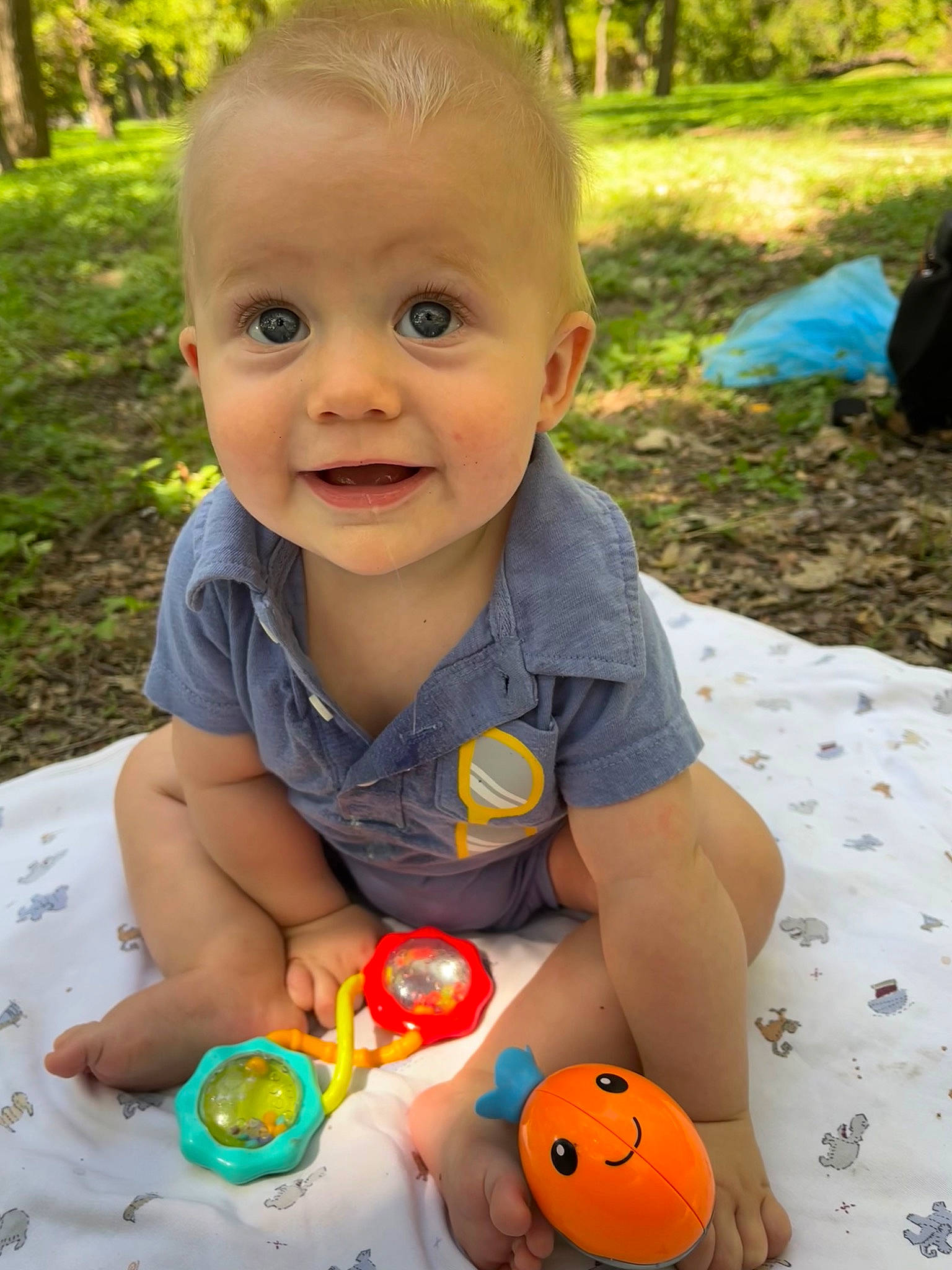 Leland is registered to the contest to win money with this photo: baby, baby_playing_with_toys, baby_toddler_clothing, cheek, child, eye, face, fun, grass, green, happy, head, joy, leisure, nose, people_in_nature, person, plant, smile, toddler