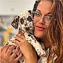 Bruno is registered to the contest to win money with this photo: affection, animal, closeup, cute, dalmatian, dog, face, friendly, glasses, hands, holding, indoor, love, nail_art, person, pet, portrait, puppy, spotted, woman