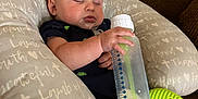 Noel joined the competition — help win amazing prizes! baby, sleeping, bottle, pillow, couch, toy, infant, child, face, hand, clothing, comfort, nap, indoor, peaceful, relaxation, furniture, cute, rest, young