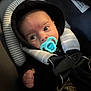 Kingsley joined the competition — help win amazing prizes! baby, baby_clothes, bundle, car_seat, child, closeup, clothing, cute, face, hood, indoor, infant, looking_away, newborn, pacifier, safety, seatbelt, small_hand, soft_lighting, stripes