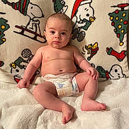 Kingsley joined the competition — help win amazing prizes! baby, blanket, cartoon, child, christmas, cute, diaper, face, festive, holiday, indoor, infant, pattern, person, plush, seated, smiling, snoopy, soft, toddler